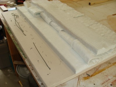 DSC02480.jpg (111.84 KiB) Viewed 54499 times Flipped right side up. The element ends are poking through. The little marks that look like ants are the bent ends of the wires securing the elements. Ceramic fibre blanket covers it and insulates it from the expanded metal lid. The element ends were brought up safely to the connectors in an enclosure on top of the expanded metal lid.